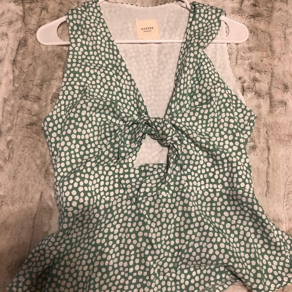 Francesca’s green and white poka-dot blouse.